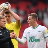 Eddie Howe, Manager of Newcastle United, shakes hands with Matt Targett of Newcastle United following the Premier League match between Manchester United and Newcastle United at Old Trafford on October 16, 2022 in Manchester, England.
