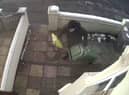 A CCTV camera captured the moment a Christmas parcel was stolen only minutes after an Evri delivery driver bizarrely hid the package under a wheely bin outside the front door. 