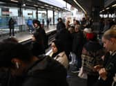 Commuters wait for an extremely delayed Central Line train at Stratford station in London on December 13  as rail strikes began a wave of festive walkouts in the country.