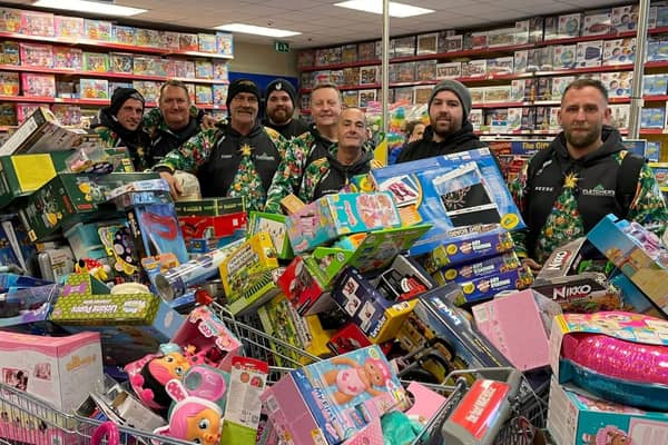 Reese, far right, and his team with some of hundreds of toys they bough from Smyth's Toy Shop