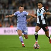 Jacob Murphy holds off the challenge of Jamie Shackleton  during the Premier League match between Newcastle United and Leeds United  (Photo by Stu Forster/Getty Images)