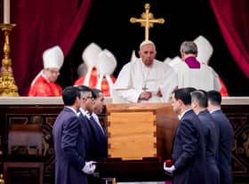 Pope Francis attends the funeral mass for Pope Emeritus Benedict XVI as pallbearers carry the coffin at the end of the funeral mass at St. Peter's square