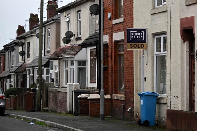 An Purple Bricks estate agent's 'sold' board is pictured on a house in a row of terraced homes on a residential street in Lees near Oldham, northern England on November 2, 2022. (Photo by Oli SCARFF / AFP) (Photo by OLI SCARFF/AFP via Getty Images)