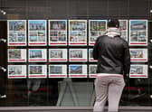 A member of the public looks at residential properties displayed for sale in the window of an estate agents' in London on September 30, 2022. (Photo by ISABEL INFANTES / AFP) (Photo by ISABEL INFANTES/AFP via Getty Images)