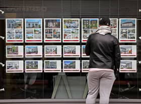 A member of the public looks at residential properties displayed for sale in the window of an estate agents' in London on September 30, 2022. (Photo by ISABEL INFANTES / AFP) (Photo by ISABEL INFANTES/AFP via Getty Images)