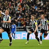 Dan Burn celebrates with teammates Miguel Almiron and Sean Longstaff after scoring the team’s first goal during the Carabao Cup Quarter Final match against Leicester City (Photo by Stu Forster/Getty Images)