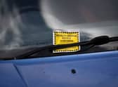 A Penalty Charge Notice (PCN) or parking ticket is pictured attached to the windscreen of a van in south London. Credit: DANIEL LEAL/AFP via Getty Images