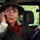 Brenda Blethyn as DCI Vera Stanhope in Vera, taking a phone call while sitting in a car (Credit: ITV)