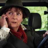 Brenda Blethyn as DCI Vera Stanhope in Vera, taking a phone call while sitting in a car (Credit: ITV)