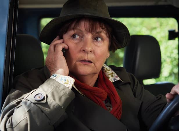 <p>Brenda Blethyn as DCI Vera Stanhope in Vera, taking a phone call while sitting in a car (Credit: ITV)</p>