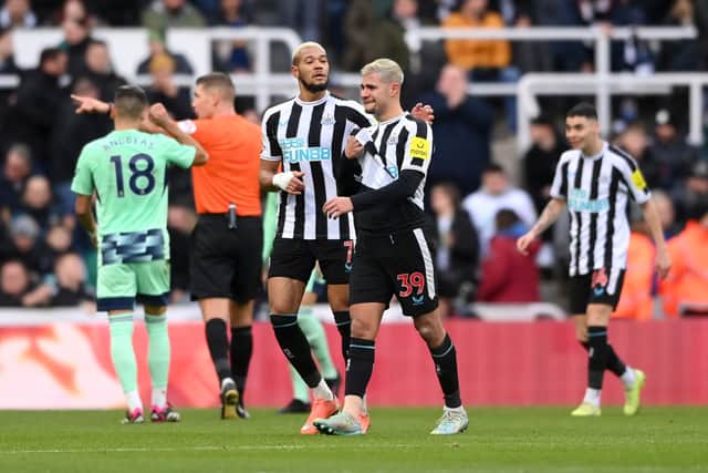 : Bruno Guimaraes leaves the pitch in tears, consoled by Joelinton of Newcastle United during the Premier League match between Newcastle United and Fulham FC at St. James Park on January 15, 2023 in Newcastle upon Tyne, England. (Photo by Stu Forster/Getty Images)