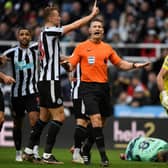 Newcastle players appeal to referee Robert Jones after Fulham’s Serbian striker Aleksandar Mitrovic (unseen) took and scored a penalty, that was later disallowed,  during the English Premier League football match between Newcastle United and Fulham at St James’ Park in Newcastle-upon-Tyne, north-east England on January 15, 2023. - RESTRICTED TO EDITORIAL USE. No use with unauthorized audio, video, data, fixture lists, club/league logos or ‘live’ services. Online in-match use limited to 120 images. An additional 40 images may be used in extra time. No video emulation. Social media in-match use limited to 120 images. An additional 40 images may be used in extra time. No use in betting publications, games or single club/league/player publications. (Photo by Oli SCARFF / AFP) / RESTRICTED TO EDITORIAL USE. No use with unauthorized audio, video, data, fixture lists, club/league logos or ‘live’ services. Online in-match use limited to 120 images. An additional 40 images may be used in extra time. No video emulation. Social media in-match use limited to 120 images. An additional 40 images may be used in extra time. No use in betting publications, games or single club/league/player publications. / RESTRICTED TO EDITORIAL USE. No use with unauthorized audio, video, data, fixture lists, club/league logos or ‘live’ services. Online in-match use limited to 120 images. An additional 40 images may be used in extra time. No video emulation. Social media in-match use limited to 120 images. An additional 40 images may be used in extra time. No use in betting publications, games or single club/league/player publications. (Photo by OLI SCARFF/AFP via Getty Images)