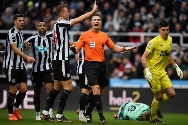 Newcastle players appeal to referee Robert Jones after Fulham’s Serbian striker Aleksandar Mitrovic (unseen) took and scored a penalty, that was later disallowed,  during the English Premier League football match between Newcastle United and Fulham at St James’ Park in Newcastle-upon-Tyne, north-east England on January 15, 2023. - RESTRICTED TO EDITORIAL USE. No use with unauthorized audio, video, data, fixture lists, club/league logos or ‘live’ services. Online in-match use limited to 120 images. An additional 40 images may be used in extra time. No video emulation. Social media in-match use limited to 120 images. An additional 40 images may be used in extra time. No use in betting publications, games or single club/league/player publications. (Photo by Oli SCARFF / AFP) / RESTRICTED TO EDITORIAL USE. No use with unauthorized audio, video, data, fixture lists, club/league logos or ‘live’ services. Online in-match use limited to 120 images. An additional 40 images may be used in extra time. No video emulation. Social media in-match use limited to 120 images. An additional 40 images may be used in extra time. No use in betting publications, games or single club/league/player publications. / RESTRICTED TO EDITORIAL USE. No use with unauthorized audio, video, data, fixture lists, club/league logos or ‘live’ services. Online in-match use limited to 120 images. An additional 40 images may be used in extra time. No video emulation. Social media in-match use limited to 120 images. An additional 40 images may be used in extra time. No use in betting publications, games or single club/league/player publications. (Photo by OLI SCARFF/AFP via Getty Images)