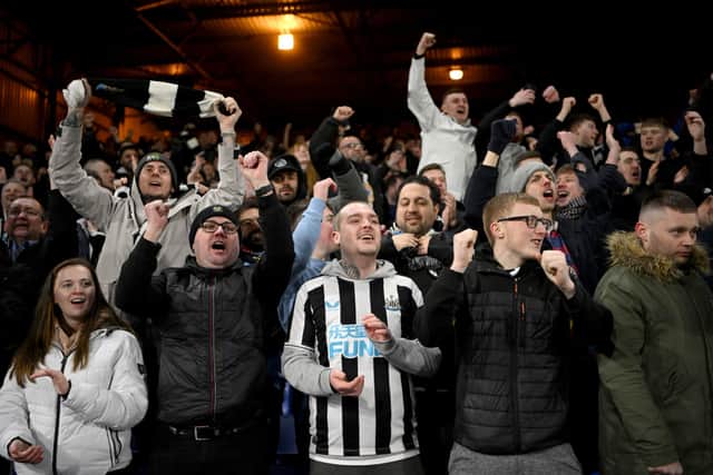 Fans of Newcastle United celebrate during the Premier League match between Crystal Palace and Newcastle United at Selhurst Park on January 21, 2023 in London, England. 