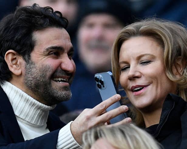 Newcastle United's owners Amanda Staveley (R) looks at her husband Mehrdad Ghodoussi's phone, ahead of the English Premier League football match between Newcastle United and Fulham at St James' Park in Newcastle-upon-Tyne, north-east England on January 15, 2023. - RESTRICTED TO EDITORIAL USE. No use with unauthorized audio, video, data, fixture lists, club/league logos or 'live' services. Online in-match use limited to 120 images. An additional 40 images may be used in extra time. No video emulation. Social media in-match use limited to 120 images. An additional 40 images may be used in extra time. No use in betting publications, games or single club/league/player publications. (Photo by Oli SCARFF / AFP) / RESTRICTED TO EDITORIAL USE. No use with unauthorized audio, video, data, fixture lists, club/league logos or 'live' services. Online in-match use limited to 120 images. An additional 40 images may be used in extra time. No video emulation. Social media in-match use limited to 120 images. An additional 40 images may be used in extra time. No use in betting publications, games or single club/league/player publications. / RESTRICTED TO EDITORIAL USE. No use with unauthorized audio, video, data, fixture lists, club/league logos or 'live' services. Online in-match use limited to 120 images. An additional 40 images may be used in extra time. No video emulation. Social media in-match use limited to 120 images. An additional 40 images may be used in extra time. No use in betting publications, games or single club/league/player publications. (Photo by OLI SCARFF/AFP via Getty Images)