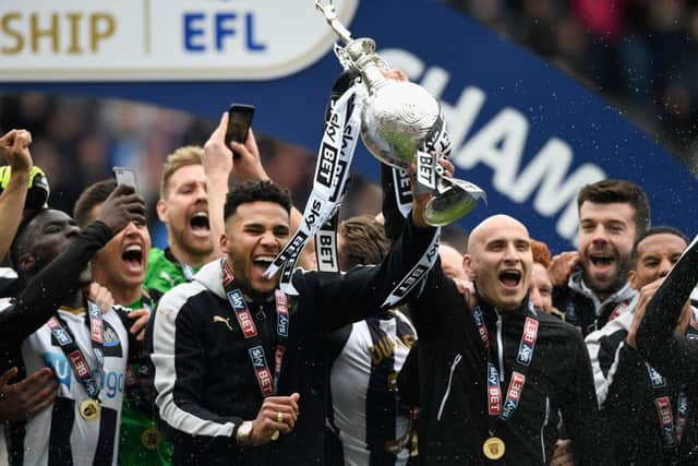 Newcastle United players Jamaal Lascelles (l) and Jonjo Shelvey lift the trophy after winning the Sky Bet Championship title after the match between Newcastle United and Barnsley at St James' Park on May 7, 2017 in Newcastle upon Tyne, England.  (Photo by Stu Forster/Getty Images)