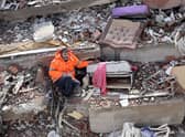 Mesut Hancer holds the hand of his 15-year-old daughter Irmak, who died in the earthquake on Monday in Kahramanmaras. Credit: ADEM ALTAN/AFP via Getty Images
