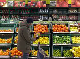 A customer shops for food items inside a Tesco supermarket store in east London on January 10, 2022.  (Photo by DANIEL LEAL/AFP via Getty Images)