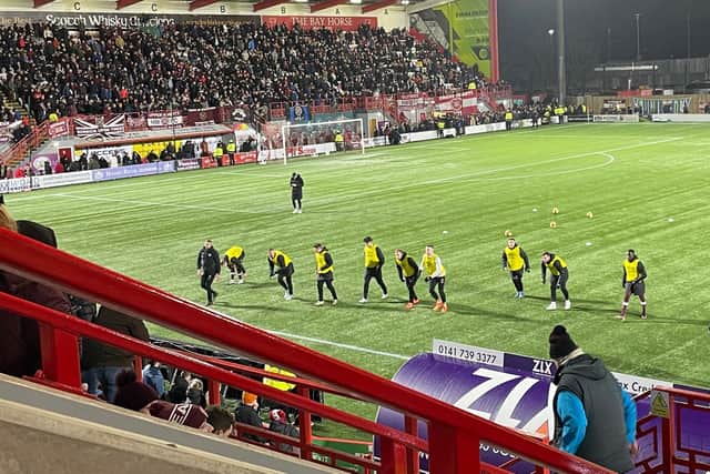 Garang Kuol (far right) warms up alongside fellow Hearts substitutes at half-time in their Scottish Cup Fifth Round tie at Hamilton Academical.
