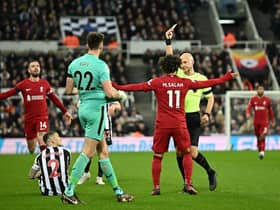 Newcastle United's English goalkeeper Nick Pope (front L) reacts after receiving a red card during the English Premier League football match between Newcastle United and Liverpool at St James' Park in Newcastle-upon-Tyne, north east England on February 18, 2023. - RESTRICTED TO EDITORIAL USE. No use with unauthorized audio, video, data, fixture lists, club/league logos or 'live' services. Online in-match use limited to 120 images. An additional 40 images may be used in extra time. No video emulation. Social media in-match use limited to 120 images. An additional 40 images may be used in extra time. No use in betting publications, games or single club/league/player publications. (Photo by Oli SCARFF / AFP) / RESTRICTED TO EDITORIAL USE. No use with unauthorized audio, video, data, fixture lists, club/league logos or 'live' services. Online in-match use limited to 120 images. An additional 40 images may be used in extra time. No video emulation. Social media in-match use limited to 120 images. An additional 40 images may be used in extra time. No use in betting publications, games or single club/league/player publications. / RESTRICTED TO EDITORIAL USE. No use with unauthorized audio, video, data, fixture lists, club/league logos or 'live' services. Online in-match use limited to 120 images. An additional 40 images may be used in extra time. No video emulation. Social media in-match use limited to 120 images. An additional 40 images may be used in extra time. No use in betting publications, games or single club/league/player publications. (Photo by OLI SCARFF/AFP via Getty Images)
