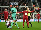 Newcastle United's English goalkeeper Nick Pope (front L) reacts after receiving a red card during the English Premier League football match between Newcastle United and Liverpool at St James' Park in Newcastle-upon-Tyne, north east England on February 18, 2023. - RESTRICTED TO EDITORIAL USE. No use with unauthorized audio, video, data, fixture lists, club/league logos or 'live' services. Online in-match use limited to 120 images. An additional 40 images may be used in extra time. No video emulation. Social media in-match use limited to 120 images. An additional 40 images may be used in extra time. No use in betting publications, games or single club/league/player publications. (Photo by Oli SCARFF / AFP) / RESTRICTED TO EDITORIAL USE. No use with unauthorized audio, video, data, fixture lists, club/league logos or 'live' services. Online in-match use limited to 120 images. An additional 40 images may be used in extra time. No video emulation. Social media in-match use limited to 120 images. An additional 40 images may be used in extra time. No use in betting publications, games or single club/league/player publications. / RESTRICTED TO EDITORIAL USE. No use with unauthorized audio, video, data, fixture lists, club/league logos or 'live' services. Online in-match use limited to 120 images. An additional 40 images may be used in extra time. No video emulation. Social media in-match use limited to 120 images. An additional 40 images may be used in extra time. No use in betting publications, games or single club/league/player publications. (Photo by OLI SCARFF/AFP via Getty Images)