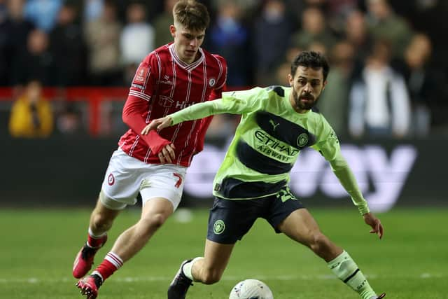 Scott in action against Manchester City