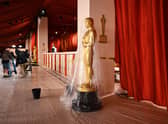 A bucket collects water leaking from the ceiling as rain from a winter storm falls on the not so red carpet arrivals area, ahead of the 95th Academy Awards, in Hollywood, California, on March 10, 2023.