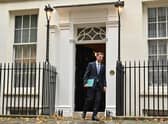 Britain's Chancellor of the Exchequer Jeremy Hunt walks out of Number 11 Downing Street 