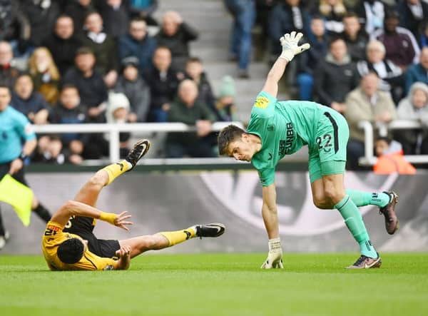 Raul Jimenez of Wolverhampton Wanderers and Nick Pope of Newcastle United collide during the Premier League match between Newcastle United and Wolverhampton Wanderers at St. James Park on March 12, 2023 in Newcastle upon Tyne, England. (Photo by Michael Regan/Getty Images)