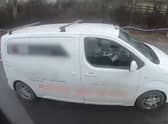 Motorists caught on camera watching a film while driving