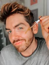 Scott McGlynn applying a serum.