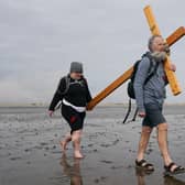  Pilgrims celebrate Easter by carrying wooden crosses as they walk over the tidal causeway to Lindisfarne during the final leg of their annual Good Friday pilgrimage.