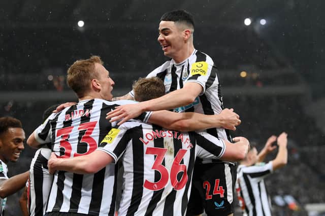 ean Longstaff of Newcastle United (obscured) celebrates with teammates Dan Burn and Miguel Almiron after scoring the team's second goal during the Carabao Cup Semi Final 2nd Leg match between Newcastle United and Southampton at St James' Park on January 31, 2023 in Newcastle upon Tyne, England. (Photo by Stu Forster/Getty Images)