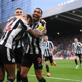 Newcastle United striker Alexander Isak celebrates with team mates Kieran Trippier (obscured) and Callum Wilson (r) after scoring the winning goal during the Premier League match between Newcastle United and Fulham FC at St. James Park on January 15, 2023 in Newcastle upon Tyne, England. (Photo by Stu Forster/Getty Images)