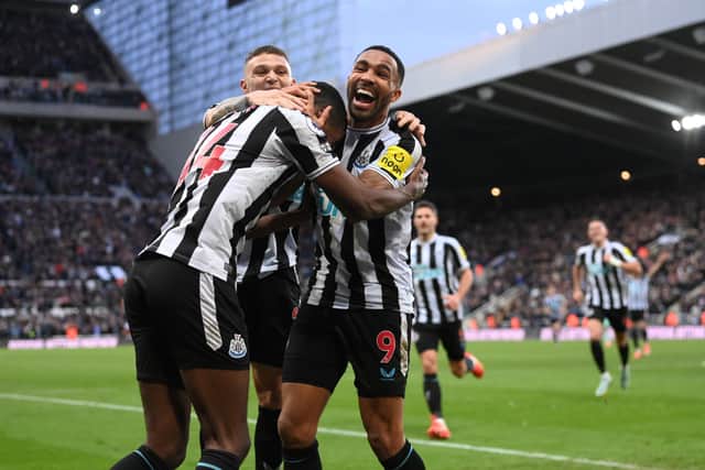 Newcastle United striker Alexander Isak celebrates with team mates Kieran Trippier (obscured) and Callum Wilson (r) after scoring the winning goal during the Premier League match between Newcastle United and Fulham FC at St. James Park on January 15, 2023 in Newcastle upon Tyne, England. (Photo by Stu Forster/Getty Images)