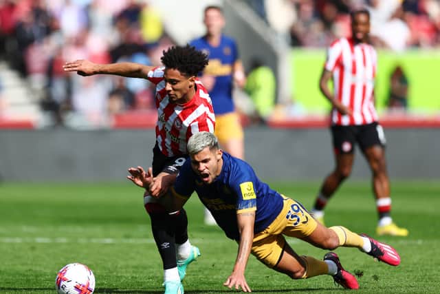Bruno Guimaraes of Newcastle United is challenged by Kevin Schade of Brentford during the Premier League match between Brentford FC and Newcastle United at Brentford Community Stadium on April 08, 2023.