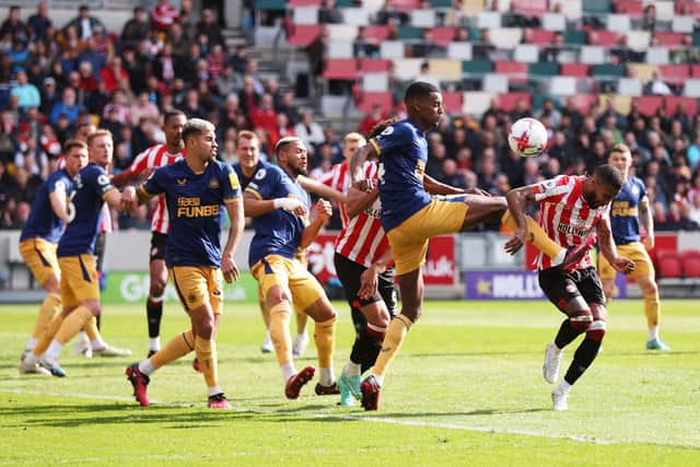 exander Isak of Newcastle United fouls Rico Henry of Brentford, which later resulted in a penalty for Brentford during the Premier League match between Brentford FC and Newcastle United at Brentford Community Stadium on April 08, 2023 in Brentford, England. (Photo by Alex Pantling/Getty Images)