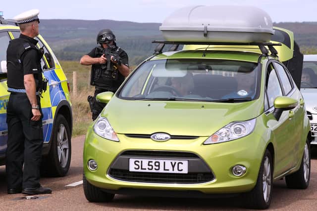JULY 06: Armed police search a vehicle leaving the village of Rothbury as the search for armed fugitive Raoul Moat goes on in the north-east of the country on July 6, 2010