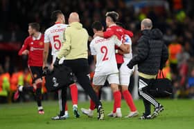 Martinez is helped off by his Argentinian teammates against Sevilla