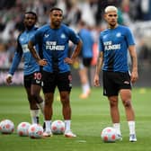 Newcastle United's French midfielder Allan Saint-Maximin (L), Newcastle United's English striker Callum Wilson (2L) and Newcastle United's Brazilian midfielder Bruno Guimaraes warm up.