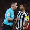 English referee David Coote (L) speaks with Newcastle United's English striker Callum Wilson (R) during the English League Cup final football match between Manchester United and Newcastle United at Wembley Stadium, north-west London on February 26, 2023. (Photo by ADRIAN DENNIS / AFP)