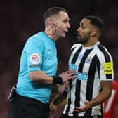 English referee David Coote (L) speaks with Newcastle United's English striker Callum Wilson (R) during the English League Cup final football match between Manchester United and Newcastle United at Wembley Stadium, north-west London on February 26, 2023. (Photo by ADRIAN DENNIS / AFP)