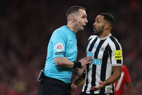 English referee David Coote (L) speaks with Newcastle United's English striker Callum Wilson (R) during the English League Cup final football match between Manchester United and Newcastle United at Wembley Stadium, north-west London on February 26, 2023. (Photo by ADRIAN DENNIS / AFP)