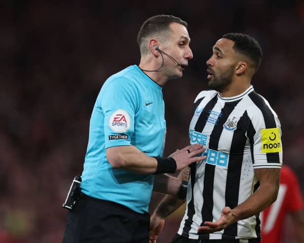 English referee David Coote (L) speaks with Newcastle United's English striker Callum Wilson (R) during the English League Cup final football match between Manchester United and Newcastle United at Wembley Stadium, north-west London on February 26, 2023. (Photo by ADRIAN DENNIS / AFP)