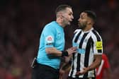 English referee David Coote (L) speaks with Newcastle United's English striker Callum Wilson (R) during the English League Cup final football match between Manchester United and Newcastle United at Wembley Stadium, north-west London on February 26, 2023. (Photo by ADRIAN DENNIS / AFP)