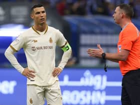 Cristiano Ronaldo (L) listens to the English referee Michael Oliver (R) during the Saudi Pro League football match between Al-Hilal and Al-Nassr at the Prince Faisal Bin Fahd stadium in the capital Riyadh on April 18, 2023. (Photo by Fayez Nureldine / AFP)