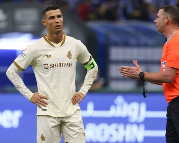Cristiano Ronaldo (L) listens to the English referee Michael Oliver (R) during the Saudi Pro League football match between Al-Hilal and Al-Nassr at the Prince Faisal Bin Fahd stadium in the capital Riyadh on April 18, 2023. (Photo by Fayez Nureldine / AFP)