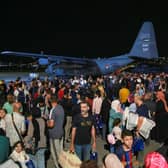 People evacuated from Sudan arrive at a military airport in Amman on 24 April 2023 (Photo: KHALIL MAZRAAWI/AFP via Getty Images)