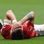 Bruno Fernandes of Manchester United lies injured during the Emirates FA Cup Semi Final match between Brighton & Hove Albion and Manchester United at Wembley Stadium on April 23, 2023 in London, England. (Photo by Matthew Peters/Manchester United via Getty Images)