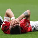 Bruno Fernandes of Manchester United lies injured during the Emirates FA Cup Semi Final match between Brighton & Hove Albion and Manchester United at Wembley Stadium on April 23, 2023 in London, England. (Photo by Matthew Peters/Manchester United via Getty Images)